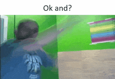 a man in a blue shirt is standing in front of a green wall with the words ok and written on the bottom