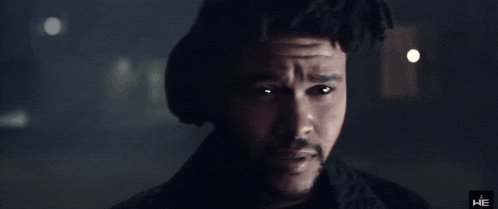 a close up of a man 's face with the letters he on the bottom
