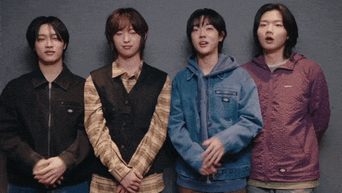 a group of young men standing next to each other with one wearing a jacket that says dickies on it