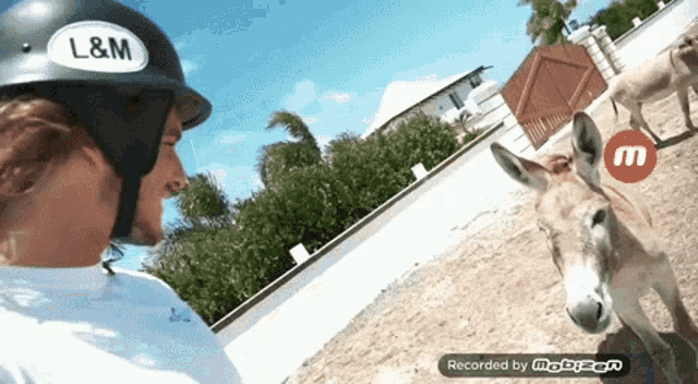 a man wearing a helmet with l & m on it