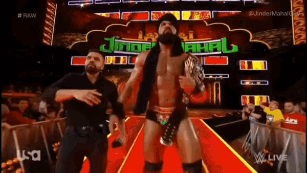 two men are dancing in front of a sign that says ' jinder mahal '