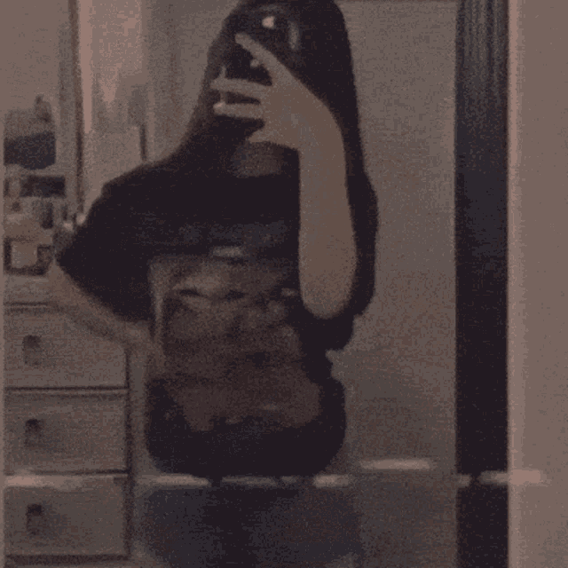a girl is taking a selfie in a mirror