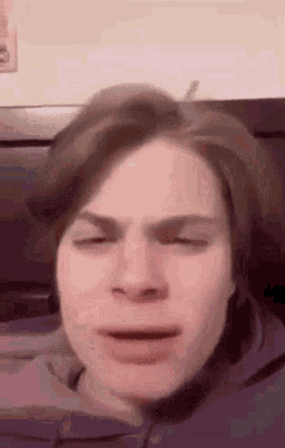 a close up of a man 's face with his eyes closed .