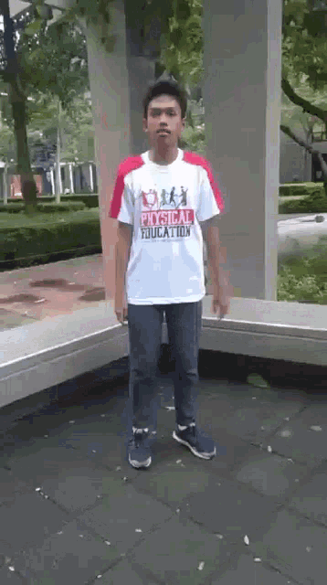 a young man wearing a physical education shirt