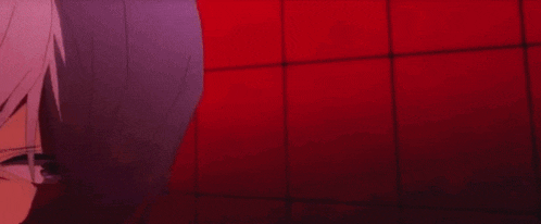 a man and a woman are standing next to each other and looking at each other in a red room .
