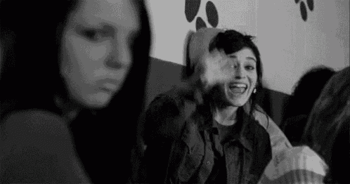 a black and white photo of a group of girls laughing and having fun .