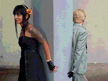 a woman in a black dress and a man in a suit standing next to each other