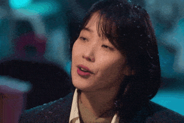 a close up of a woman 's face with snow falling on her
