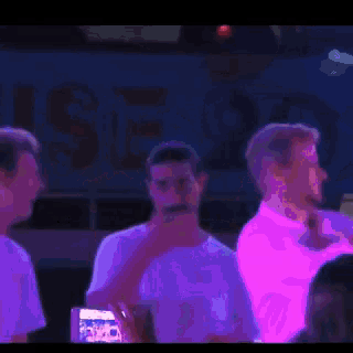 a purple light is shining on a person 's face