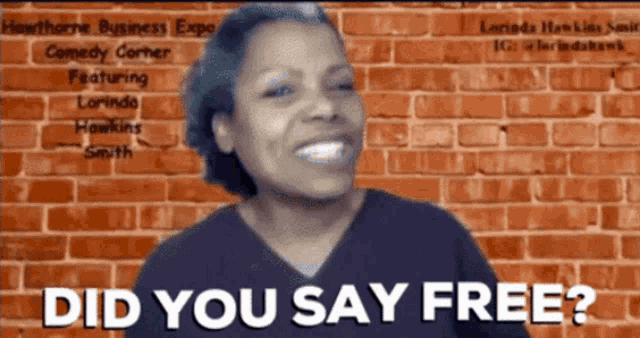 a woman is smiling in front of a brick wall and the words did you say free