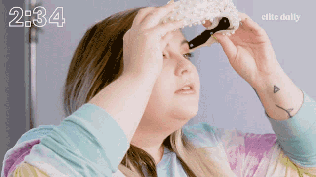 a woman is looking through a pair of binoculars with the time 2:34 on the bottom