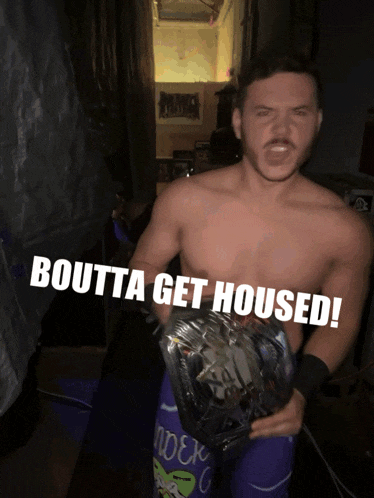 a shirtless wrestler is holding a wrestling championship belt with the words boutta get housed above him