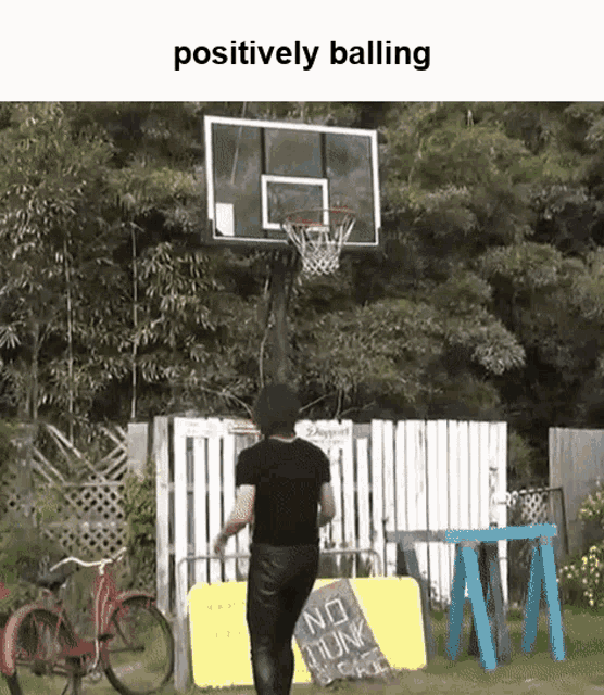 a person is playing basketball in front of a basketball hoop with the words positively balling above them