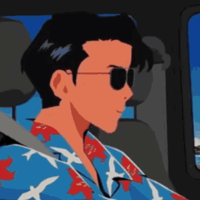 a man wearing sunglasses is sitting in a car .
