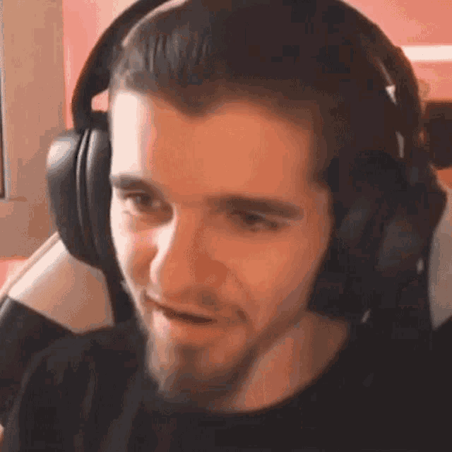 a man wearing headphones is making a funny face .