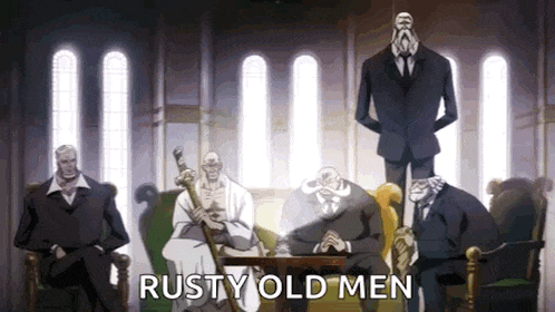 a group of men in suits and ties are sitting around a table in a room .