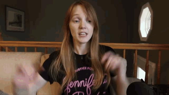 a woman wearing a black shirt that says jennifer