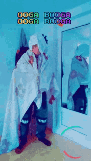 a person wrapped in a blanket standing in front of a mirror with the words doga booga doga booga on the bottom