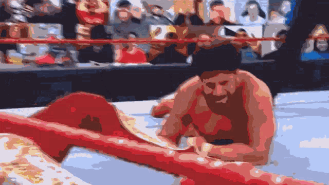 a man in a boxing ring signing a ring rope