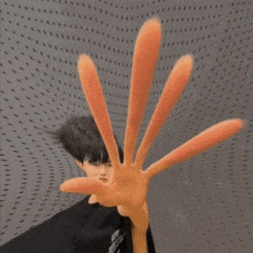 a person is holding a red object in their hand in a tunnel .