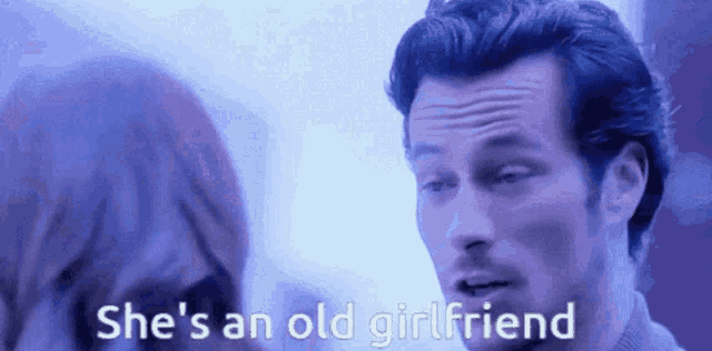 a man talking to a woman with the words she 's an old girlfriend above him