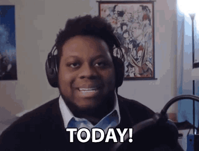 a man wearing headphones is talking into a microphone and says today