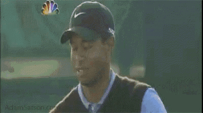 a man wearing a nike hat is holding his head in pain .