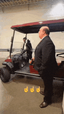 a man standing next to a golf cart that says pure on it
