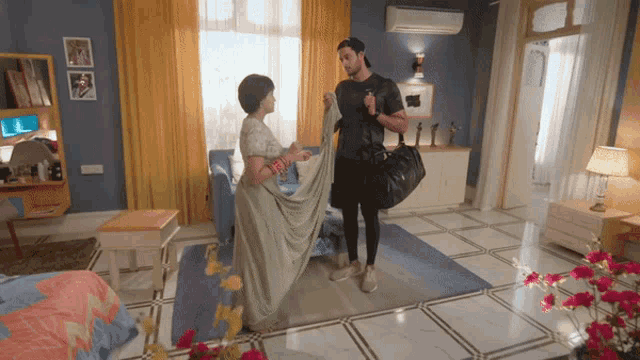 a man and woman standing in a living room