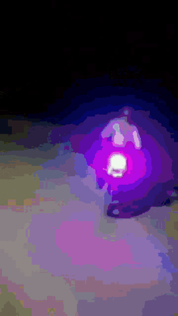 a purple light is shining on a person 's head