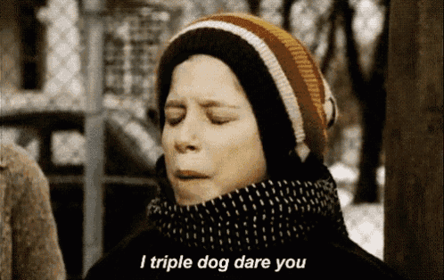 a boy wearing a hat and scarf is saying i triple dog dare you
