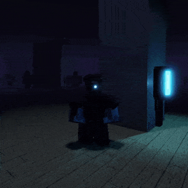 a person in a dark room with a blue light shining on them