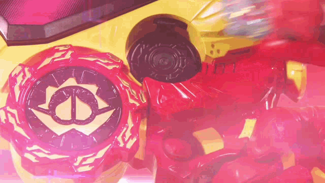 a close up of a toy with a red and yellow object