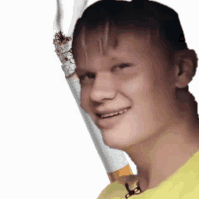 a young man in a yellow shirt is holding a cigarette in his hand