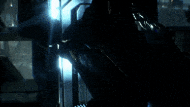 a close up of a person wearing a batman mask