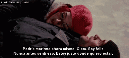 a woman in a red hat is laying on a man 's chest with a caption in spanish
