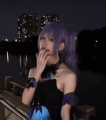 a woman with purple hair and a black dress is smoking a cigarette