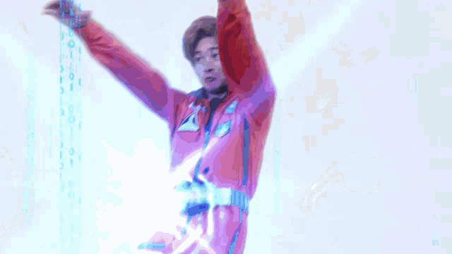 a man in a red jacket is standing with his arms outstretched in front of a blue background with numbers on it .