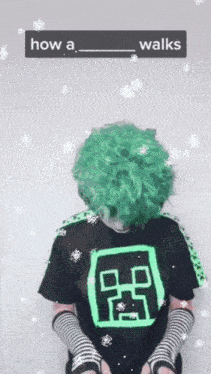 a person with green hair is wearing a black shirt that says how a walks on it