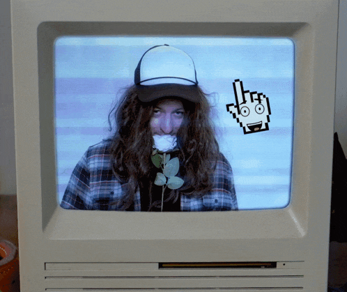 a man with a rose in his mouth is on a computer screen with a pixelated hand pointing at him