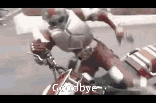 a superhero is riding a motorcycle and saying `` goodbye '' .