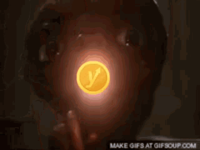a coin with the letter y on it is being thrown at a person 's face
