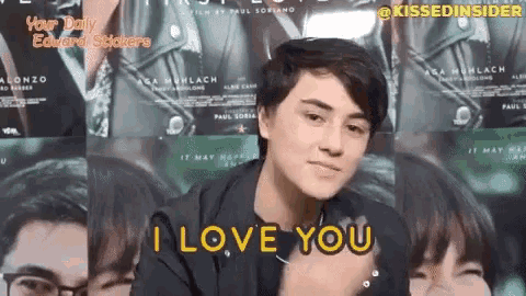 a young man says i love you in front of a wall of movie posters