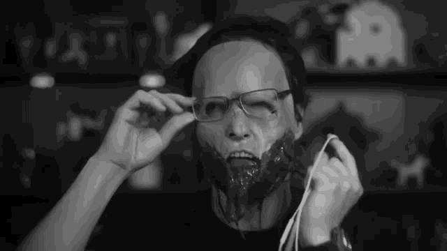 a black and white photo of a person wearing a mask