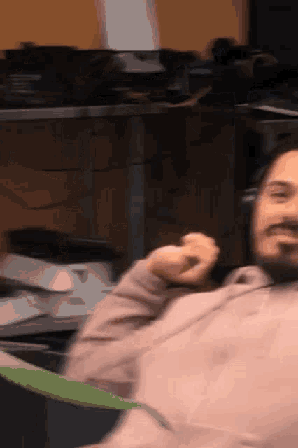 a man with a beard wearing headphones is smiling