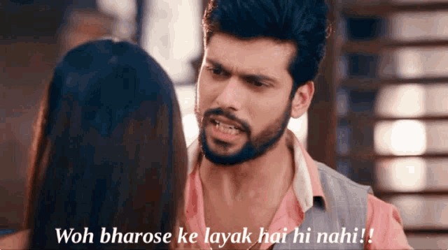 a man with a beard is looking at a woman with the words " woh bharose ke layak hai hi nahi " written below him