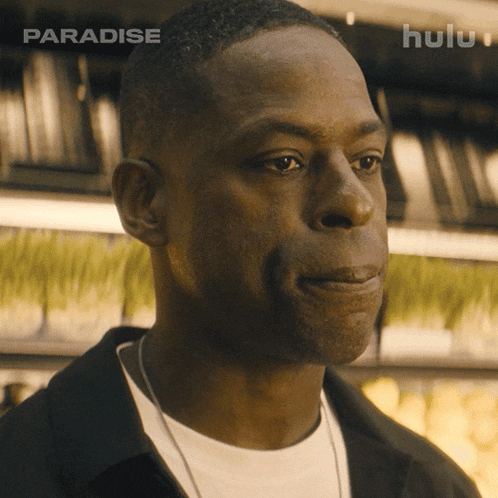 a close up of a man 's face with a hulu logo in the corner