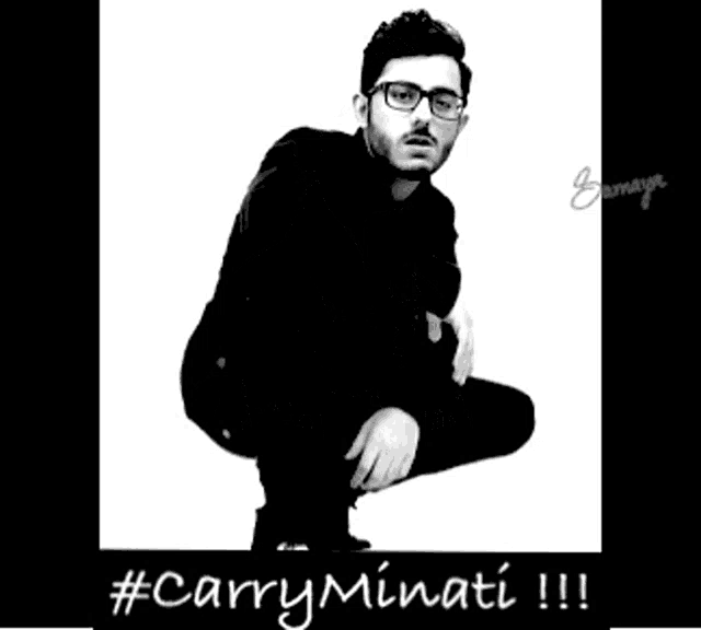 a black and white photo of a man in a suit and glasses with the hashtag #carryminati !!
