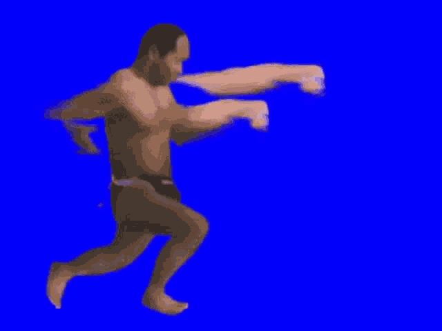 a man without a shirt is running on a blue screen with arms coming out of his body .