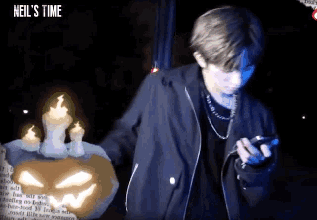 a man standing in front of a pumpkin with candles on it and the words neil 's time written on the bottom